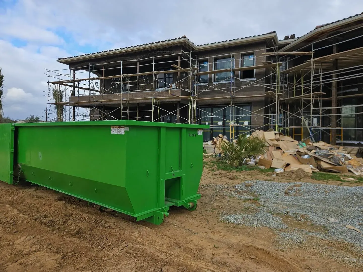 Eco Waste Dumpsters team delivering a dumpster