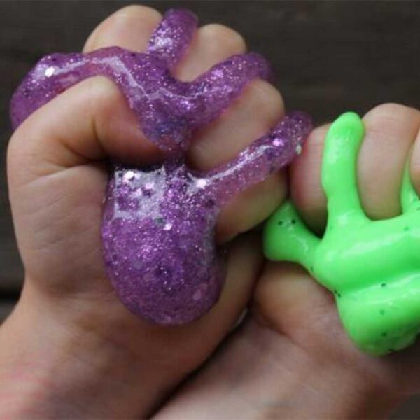 Kids' hands making colourful slime at a My Studio Party Super Slimy Party