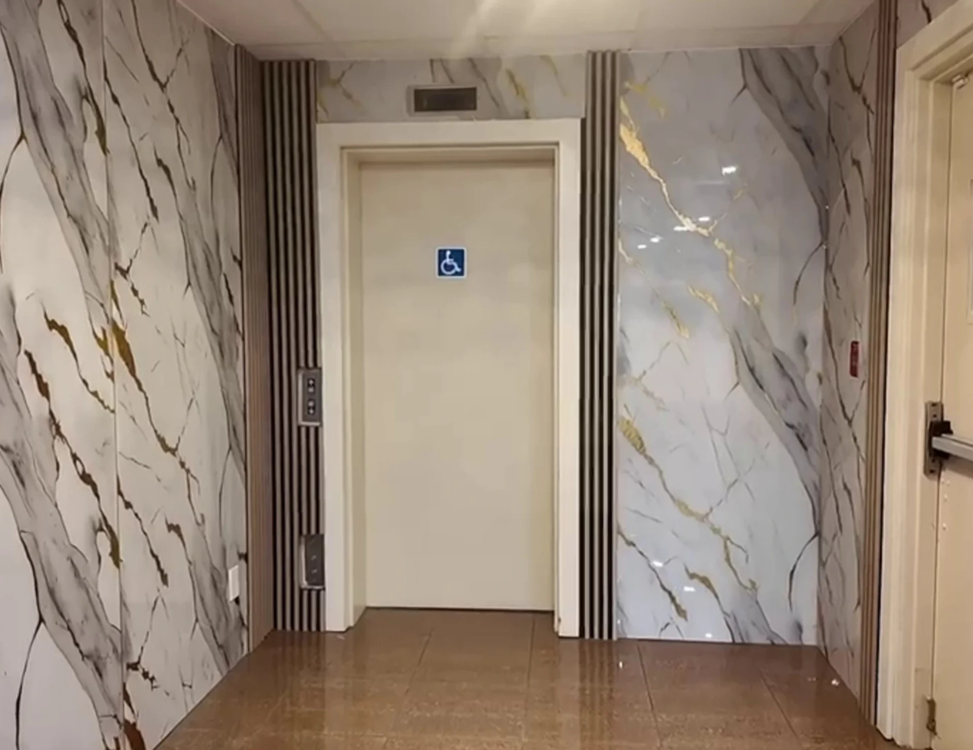 The accessible entrance and elevator with marble cladding