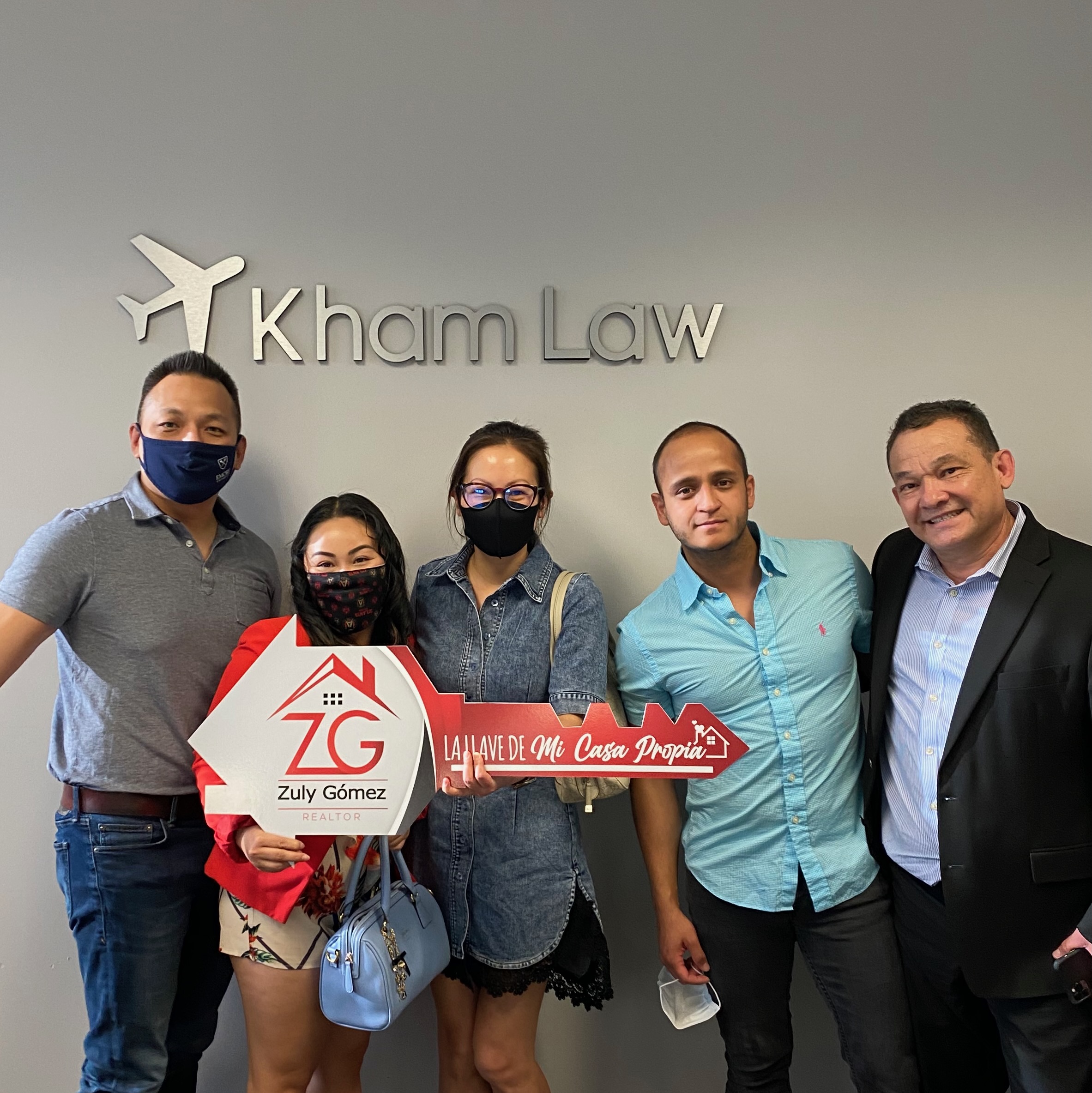 Wei with clients at a Kham Law closing