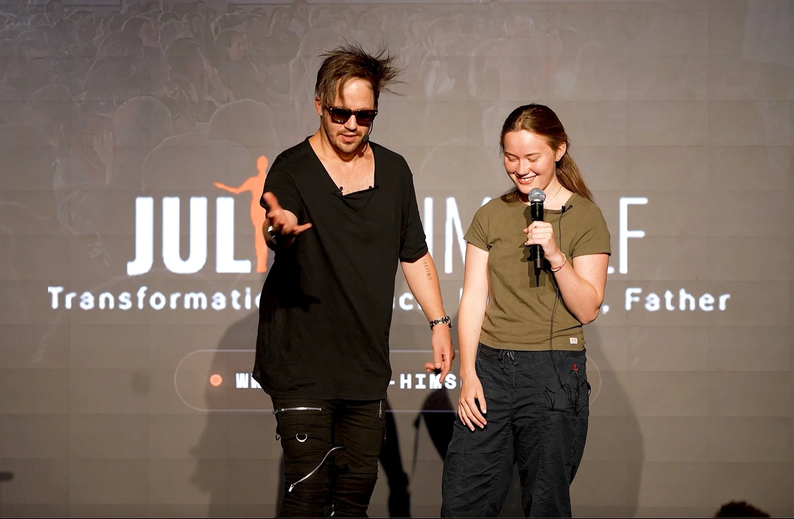 Julien coaching an audience member on stage