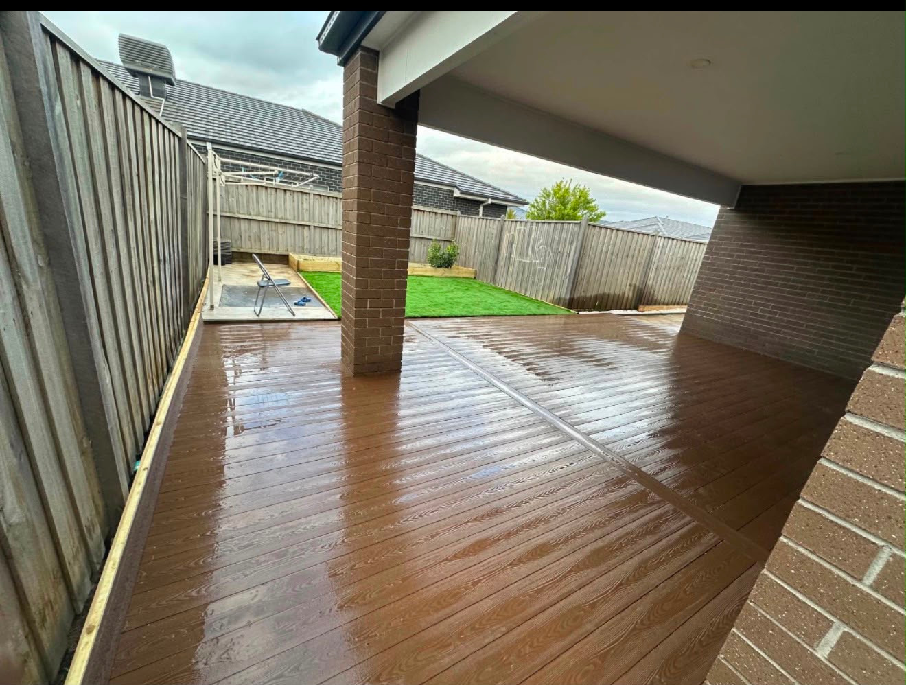 Outdoor deck extending from a covered patio to the garden