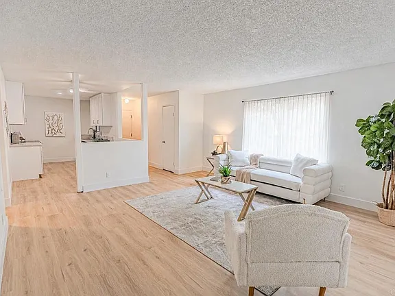 Living room with luxury vinyl plank flooring and open-concept layout at 634 8th St Apt 8