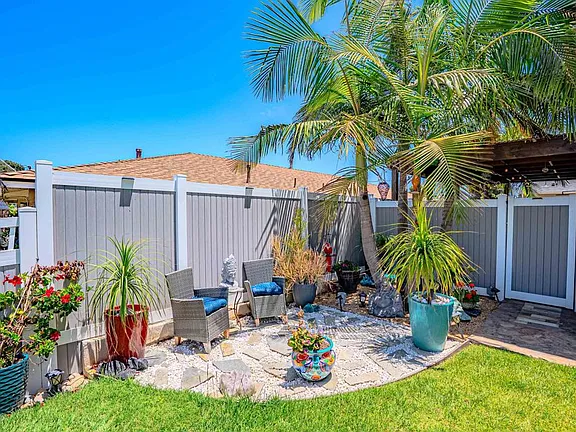 Backyard patio at 569 Delaware St with wood-plank porcelain tile and tea light pergolas