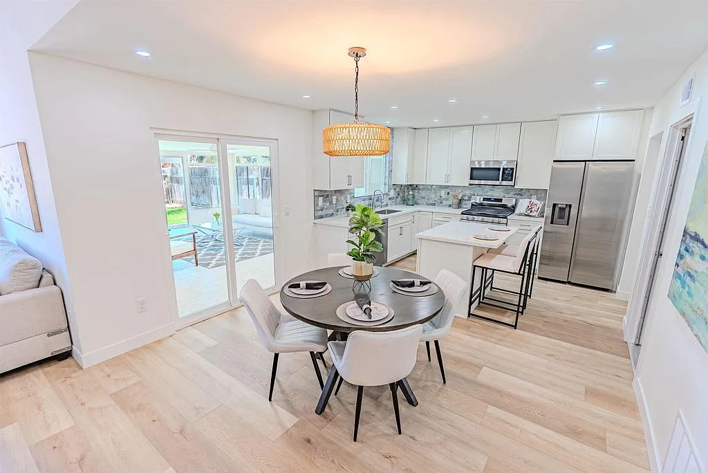 Kitchen detail showing quartz countertops and pearlescent blue subway tile backsplash at 1250 Connecticut St