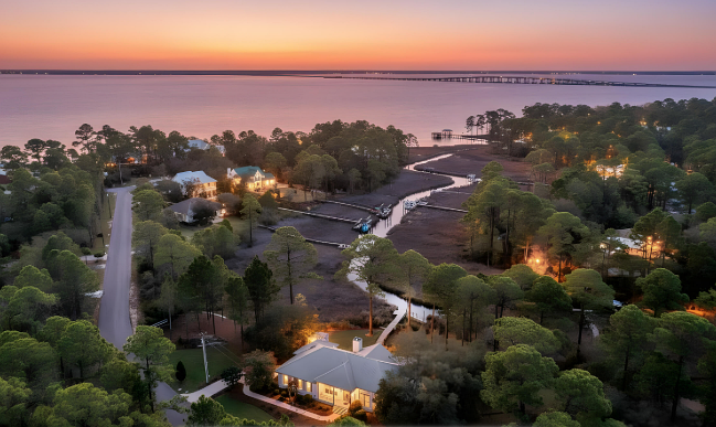 Twilight view of 252 Pisces Drive with waterfront lighting