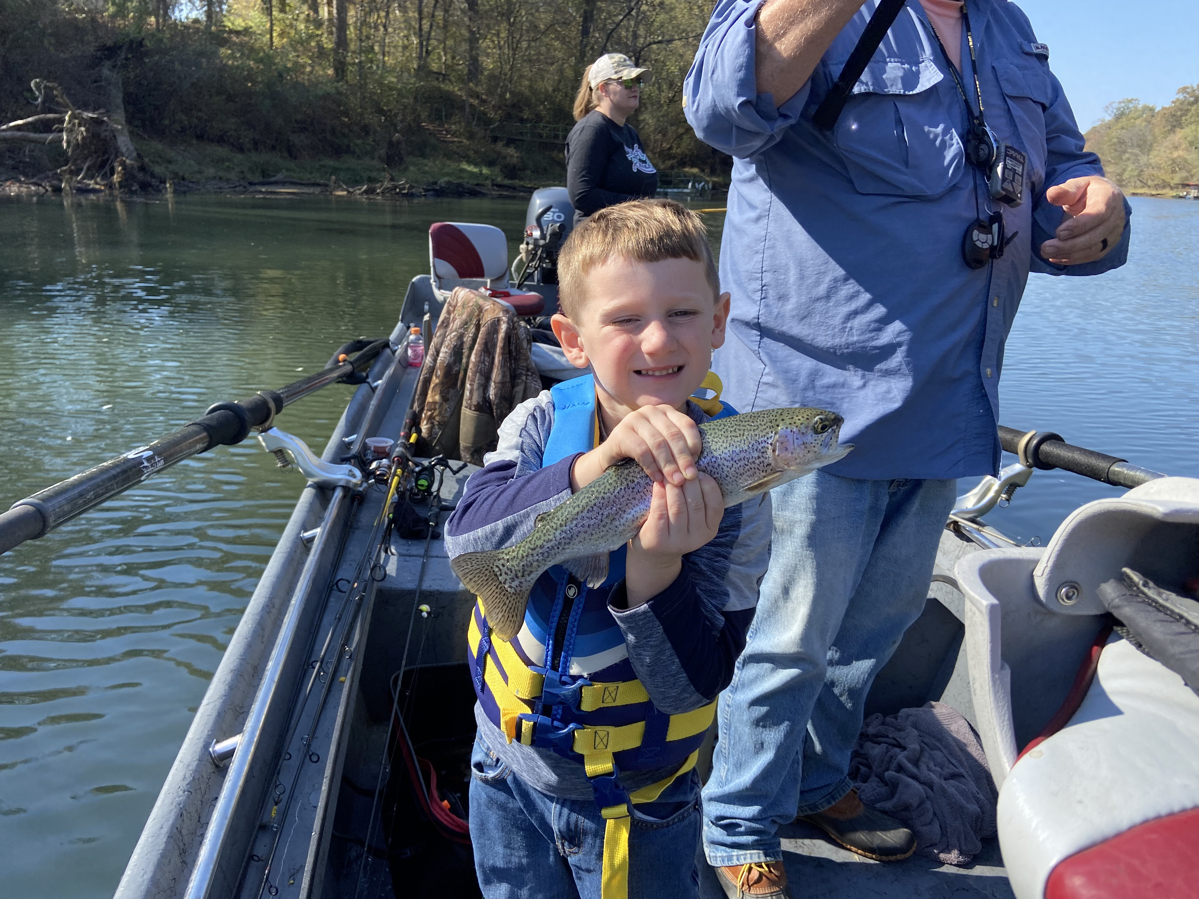 Guide pointing out fish to client on Little Red River