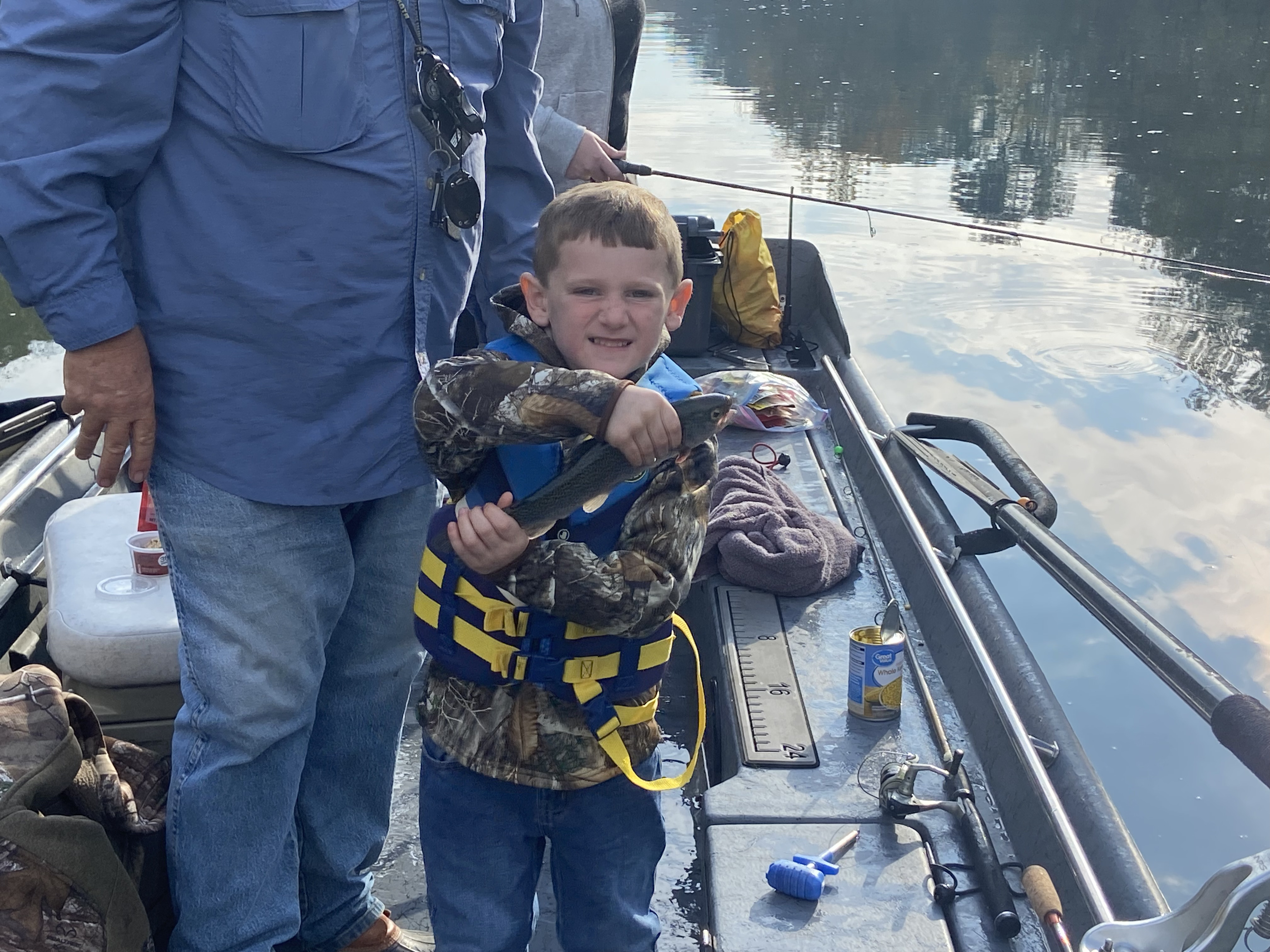 Angler releasing trophy brown trout back into cold river