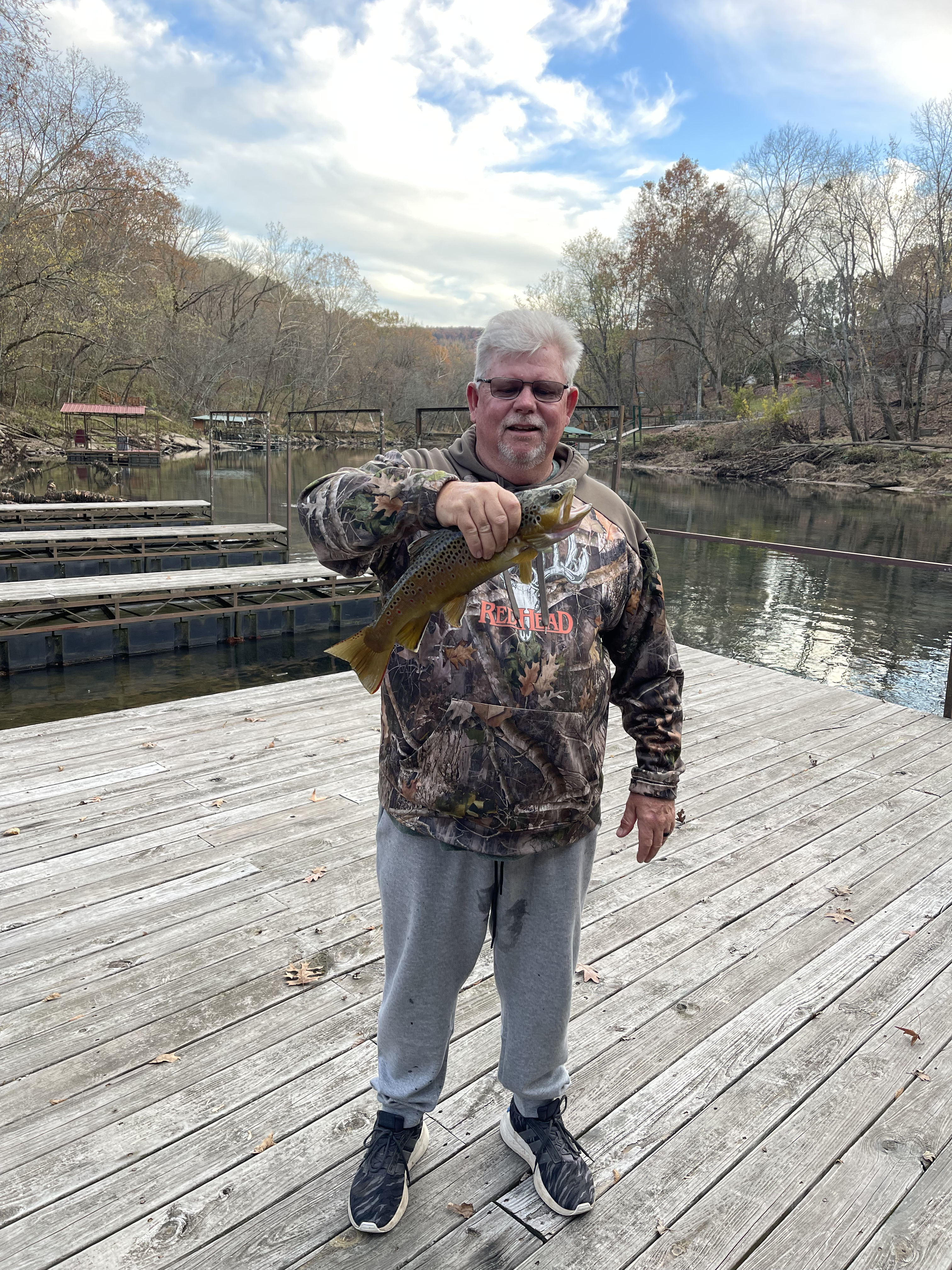 Fly fishing rod and reel with river background in golden hour