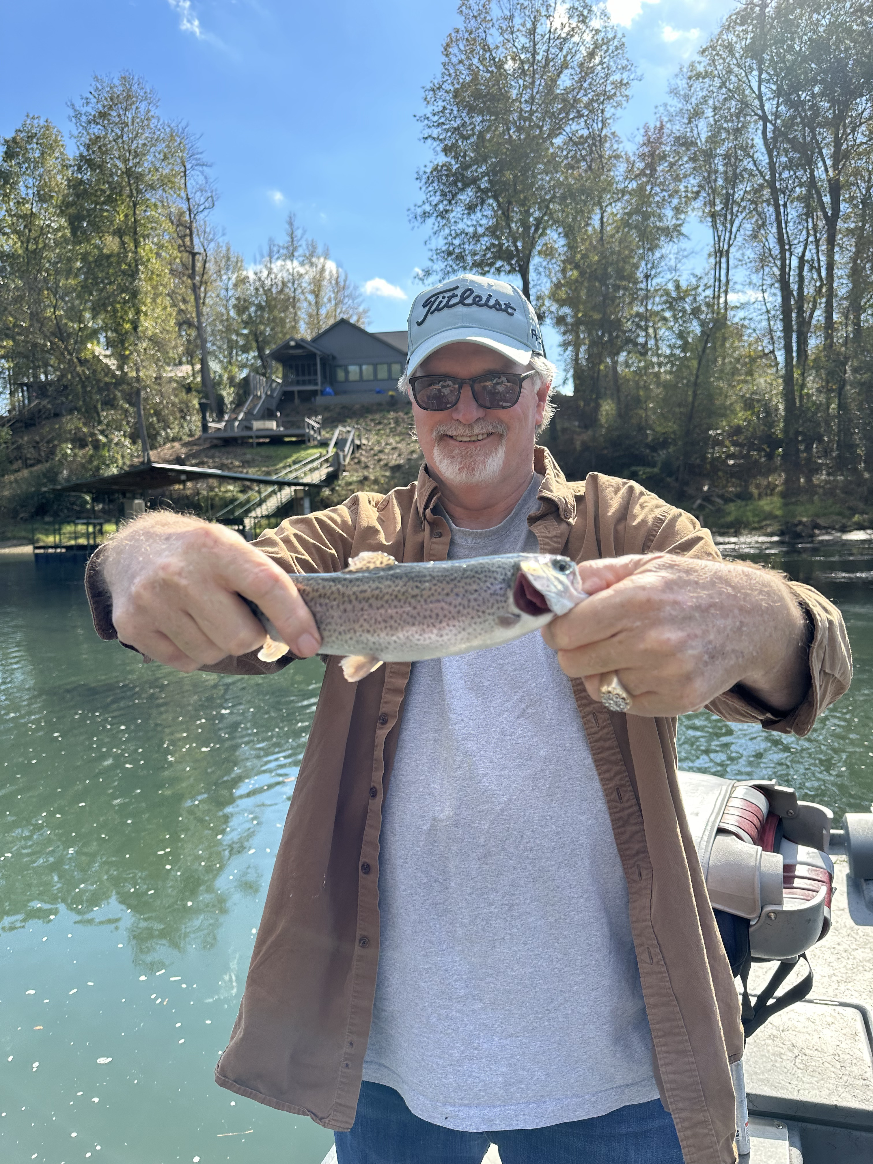 Fly fishing scene on Little Red River with guide in drift boat