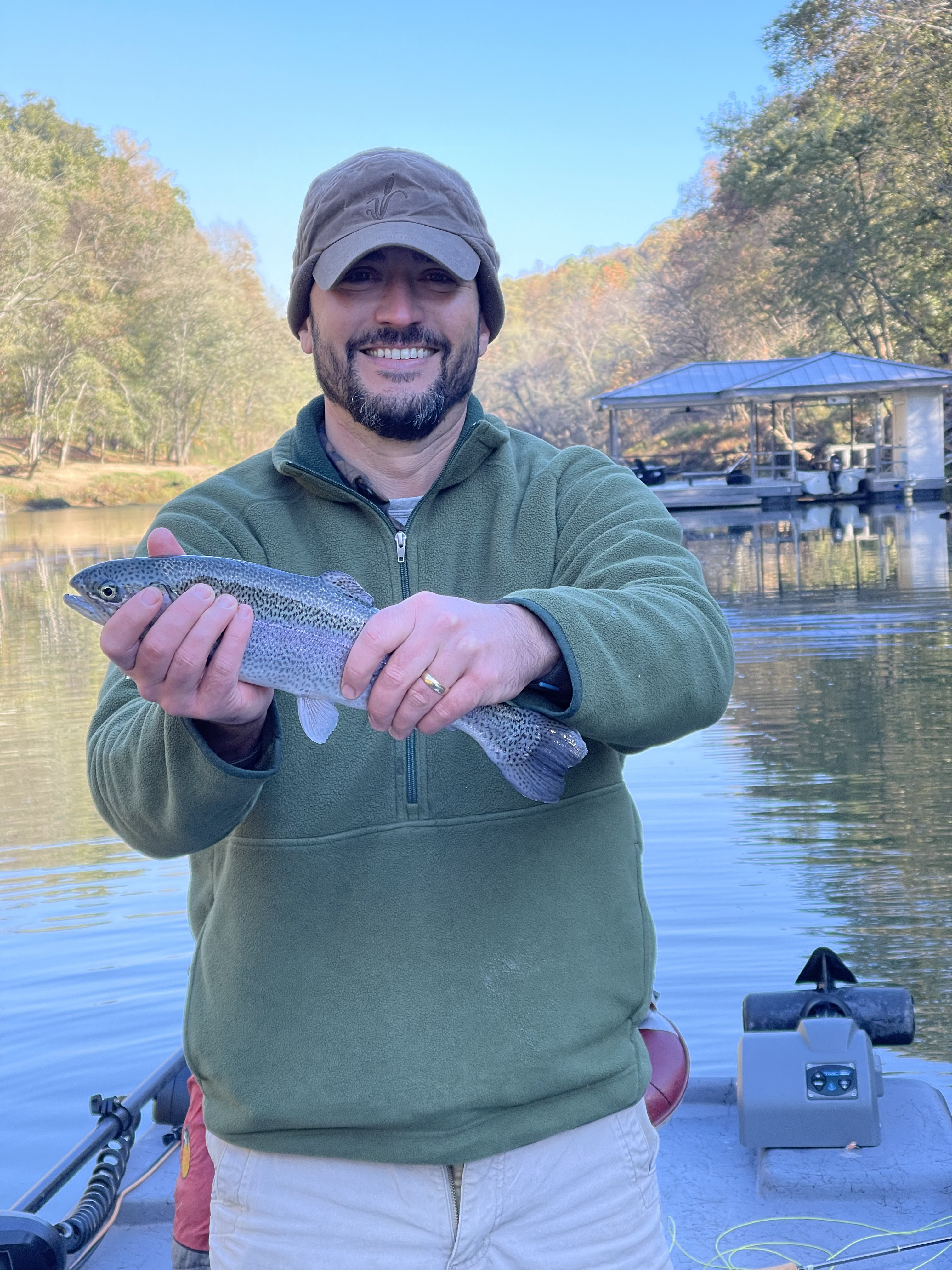 Close up of brown trout with spots in shallow clear water