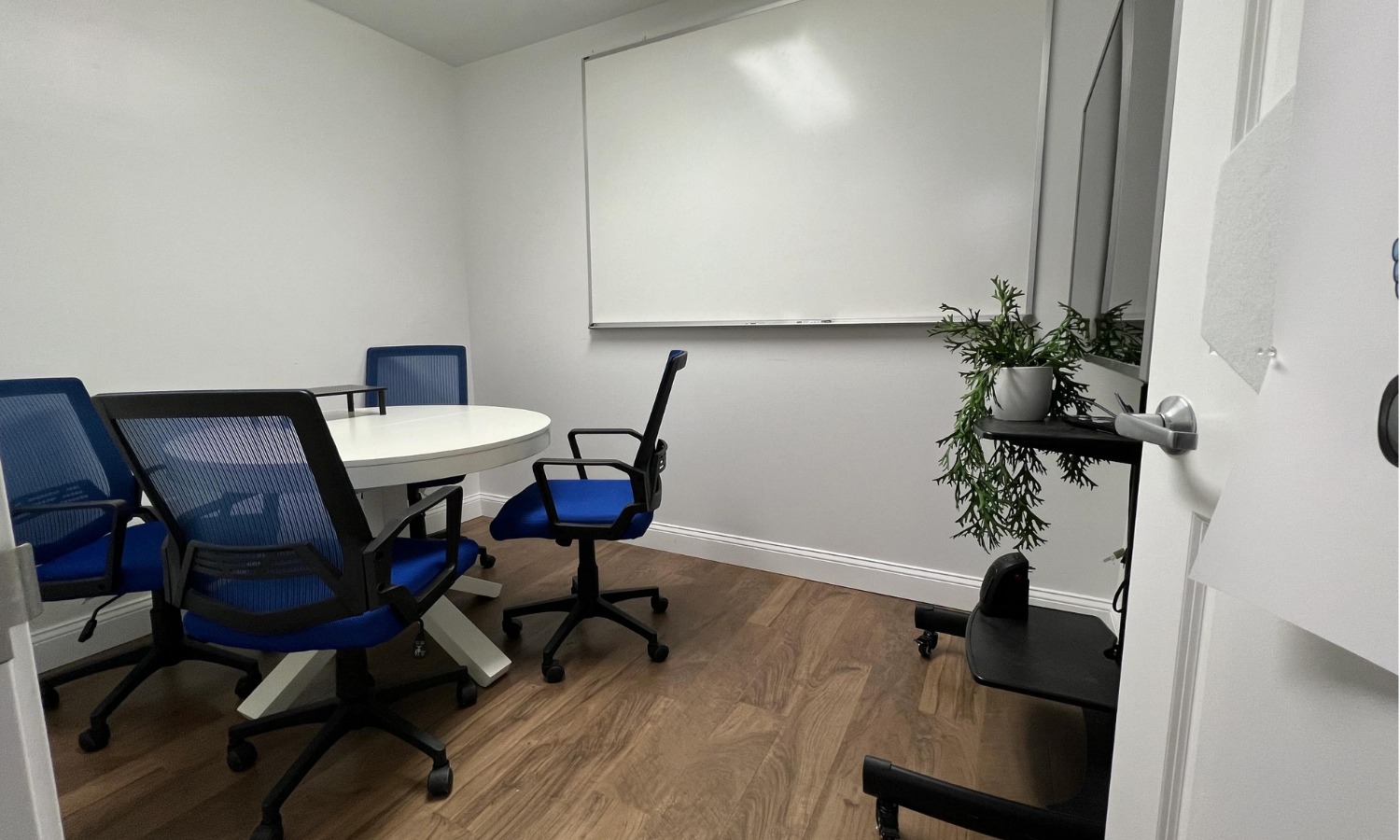 The small meeting room set for a client conversation