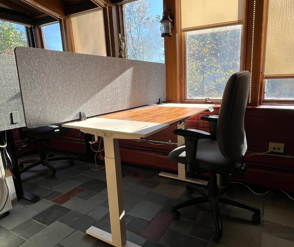 Dedicated desk with acoustic divider and ergonomic chair