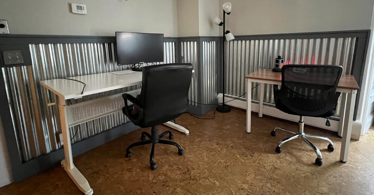A dedicated desk with sit/stand adjustment and ergonomic chair