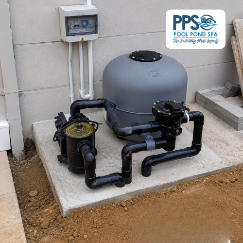 A complete pool filter installation by Pool Pond Spa, a grey sand filter, pump and multiport valve fitted with neat black pipework on a new concrete base