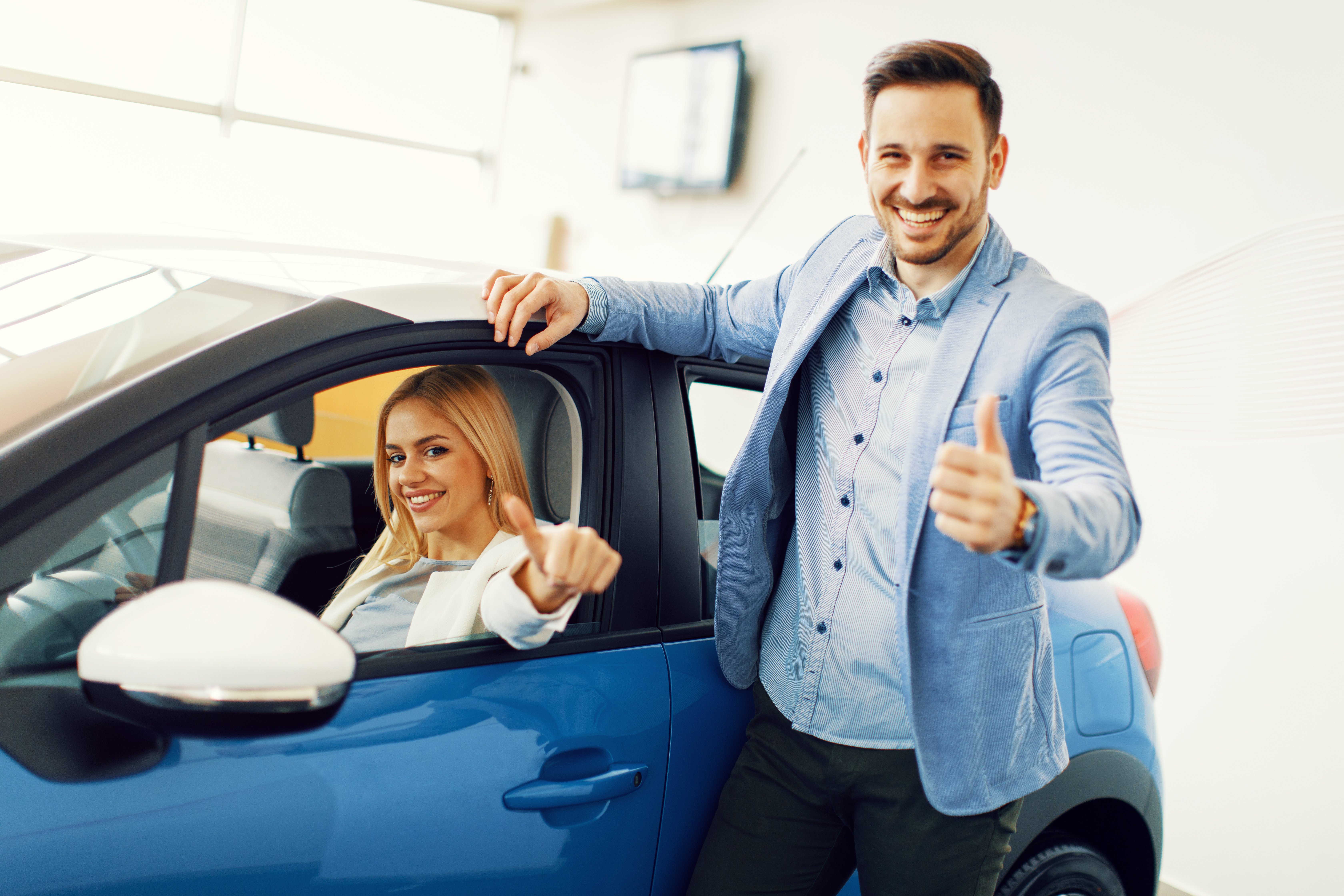 A young couple choosing a new car