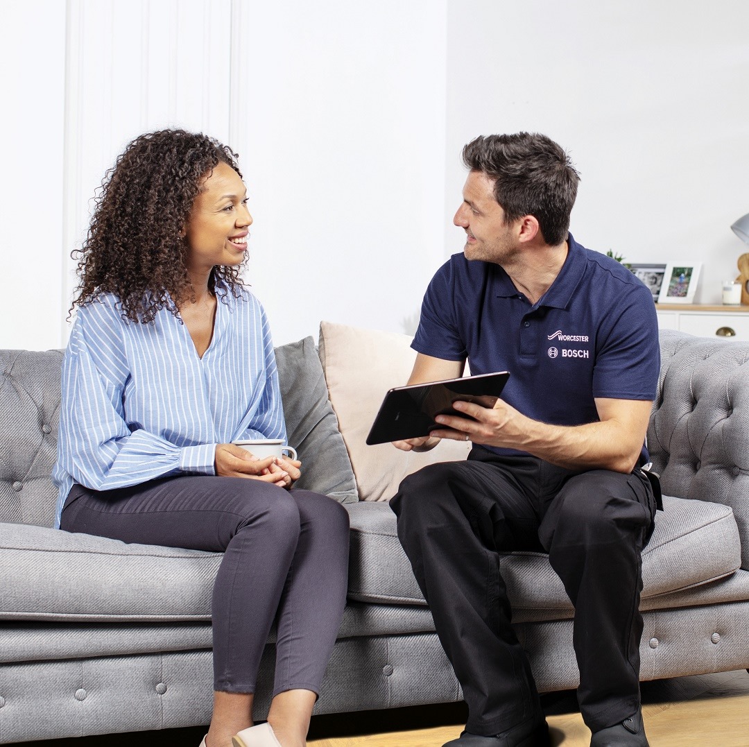 Engineer discussing boiler survey with homeowner