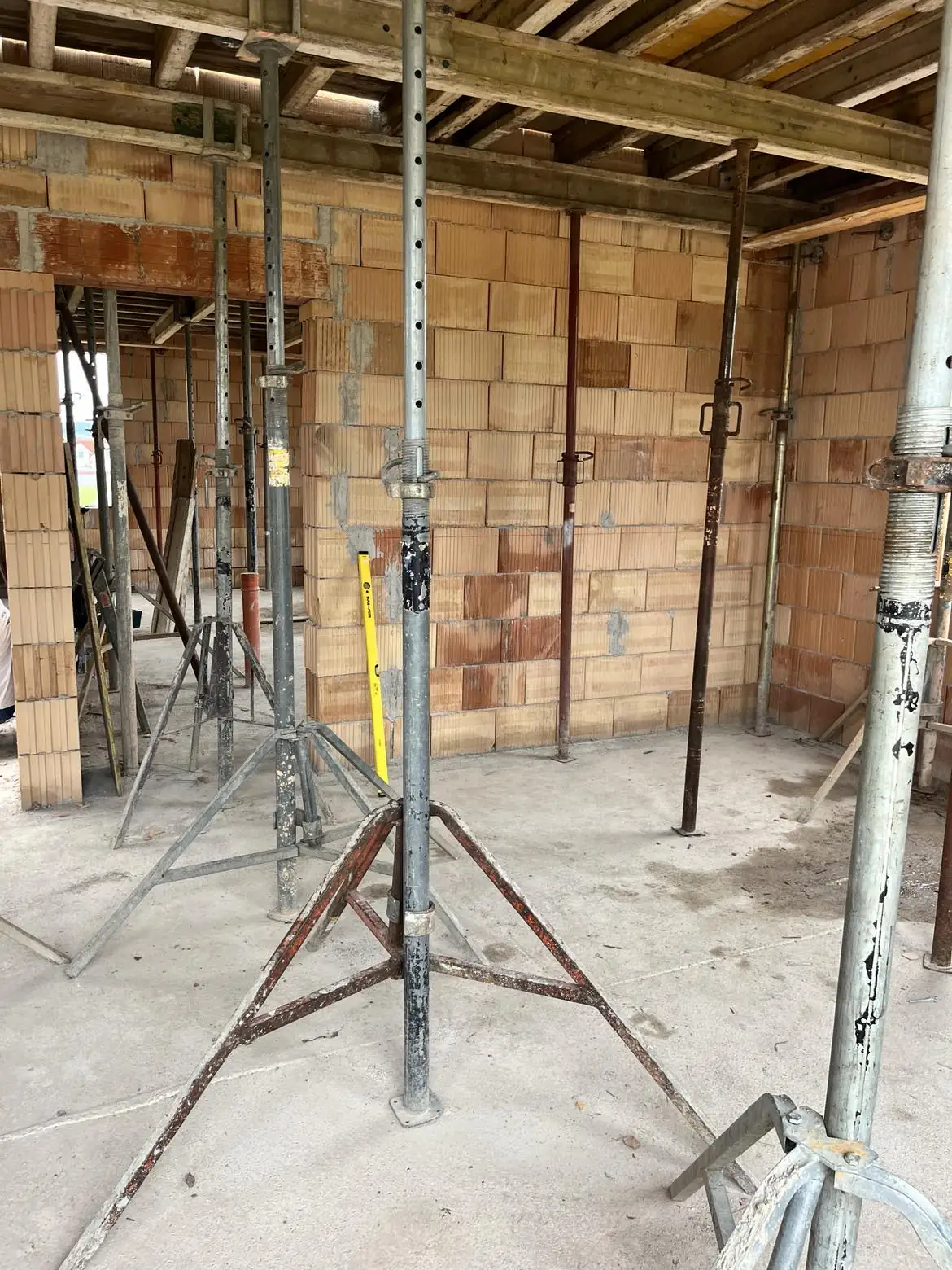 A képen a Farkas-Konstrukt Kft. által végzett generálkivitelezés munkálatai láthatók Körmend városában. A látványban acél állványok és támrendszerek találhatók, amelyek egy építkezés belső terét alkotják. A falakon látható téglák és a munkaterület rendbetétele azt mutatja, hogy a kivitelezés folyamatban van, ami a cég szakértelmét tükrözi.