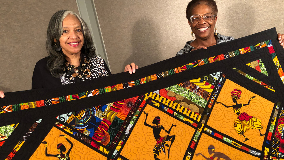 Traditional Ghanaian Kente cloth woven on narrow horizontal looms by Ashanti and Ewe artisans, featuring symbolic geometric patterns and kaleidoscopic colors like gold for wealth and red for passion. Traditional Ghanaian Kente cloth woven on narrow horizontal looms by Ashanti and Ewe artisans, featuring symbolic geometric patterns and kaleidoscopic colors like gold for wealth and red for passion.