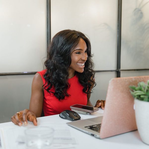 Business owner smiling at her desk