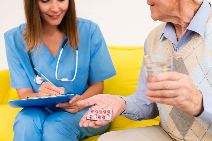 medium-shot-old-man-holding-his-pills