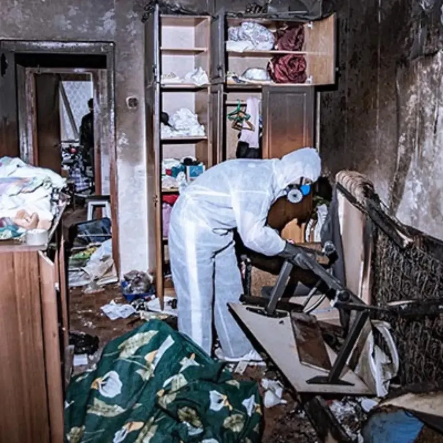 Fire damage cleanup job, technician in protective gear