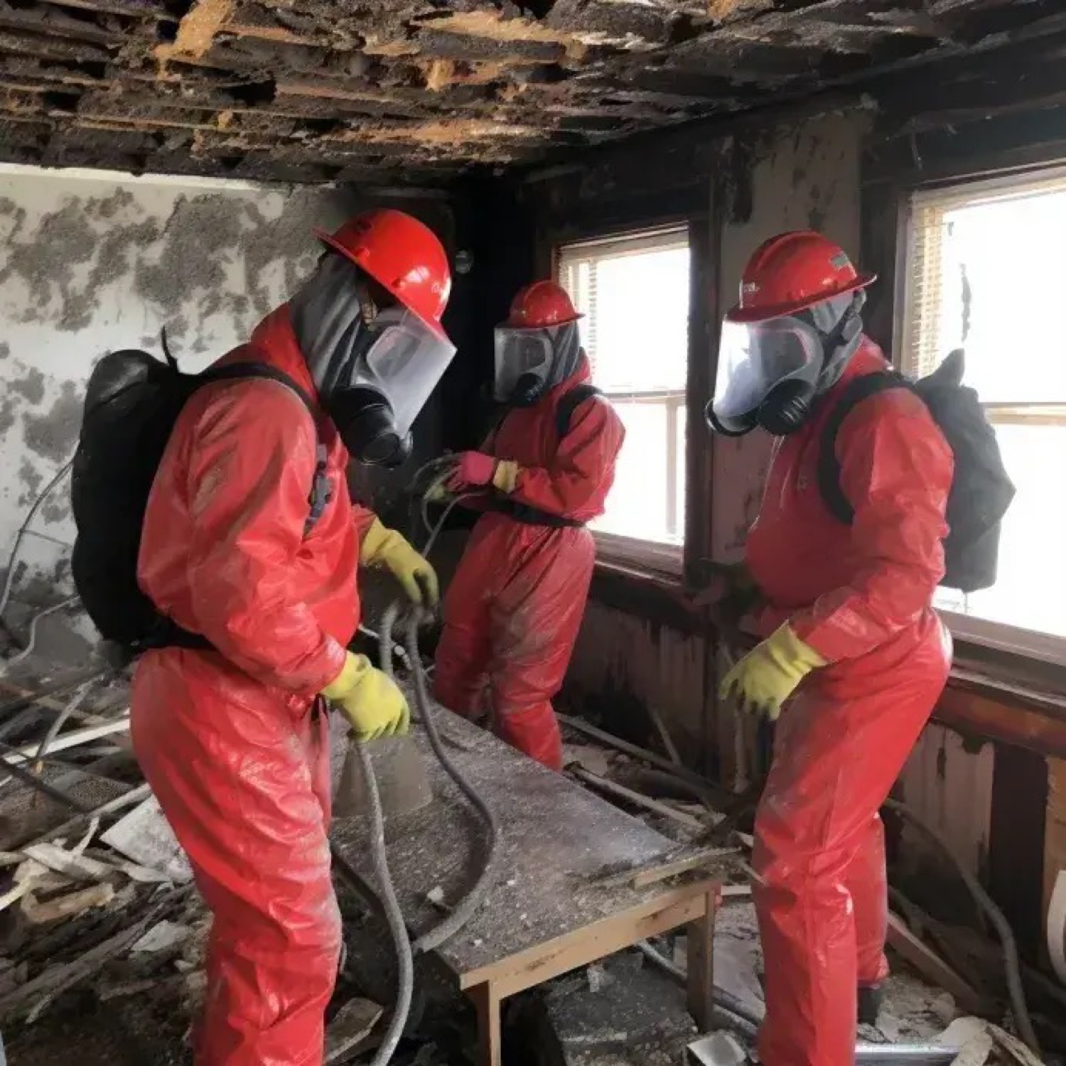 Fire damage cleanup crew in protective gear