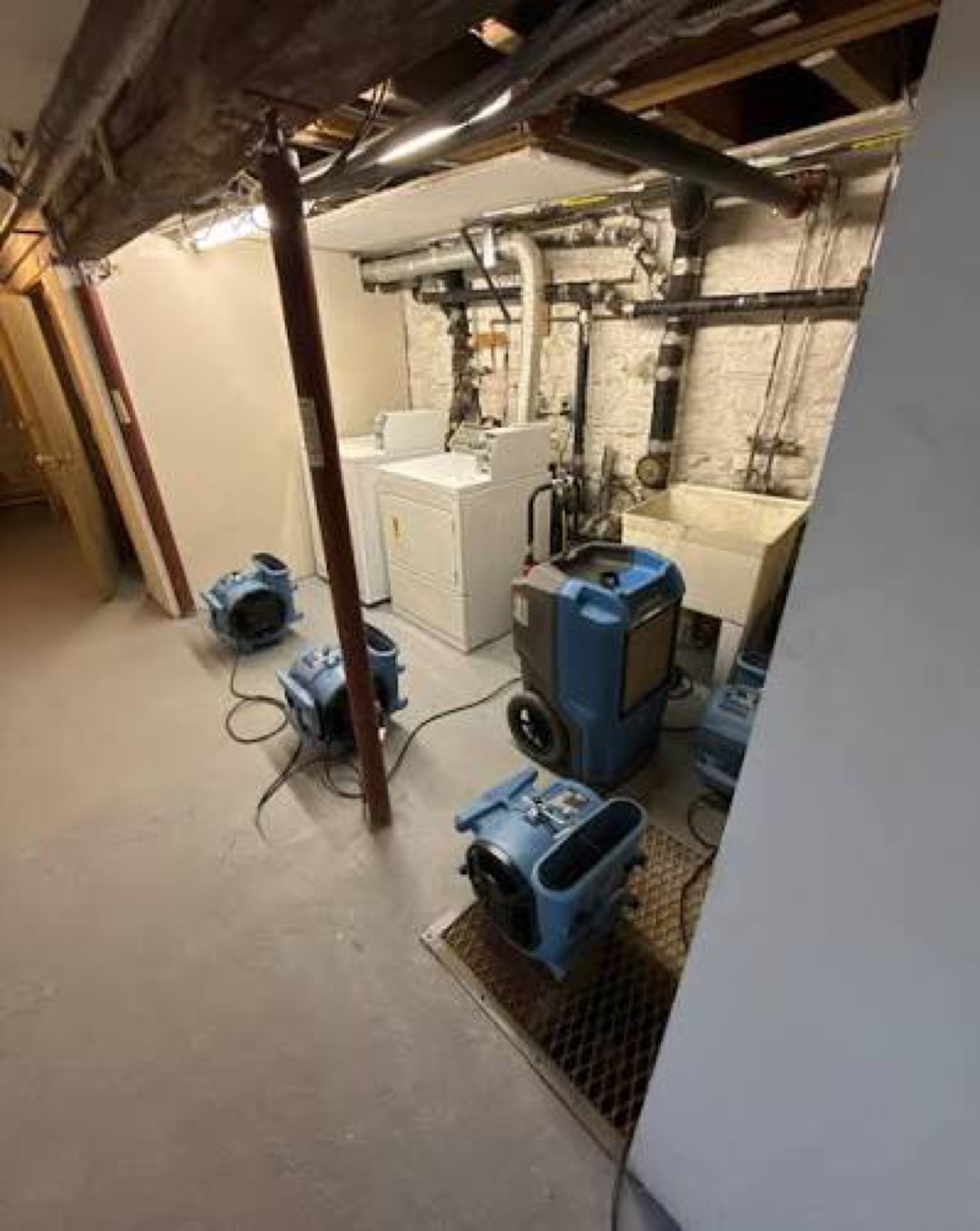 Water damage drying job with air movers and dehumidifiers