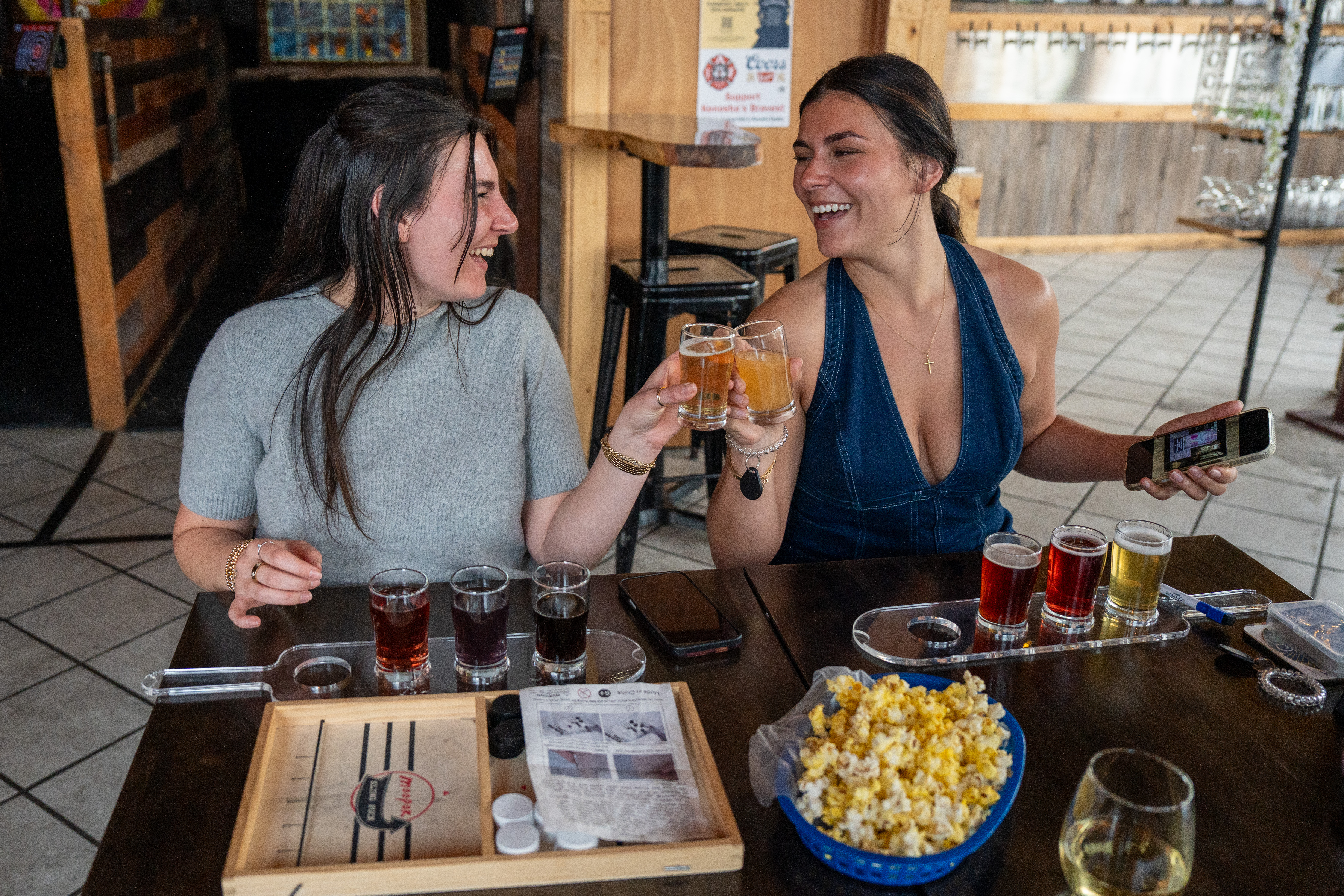 Couple enjoying drinks on a date night at Hold My Beer Kenosha