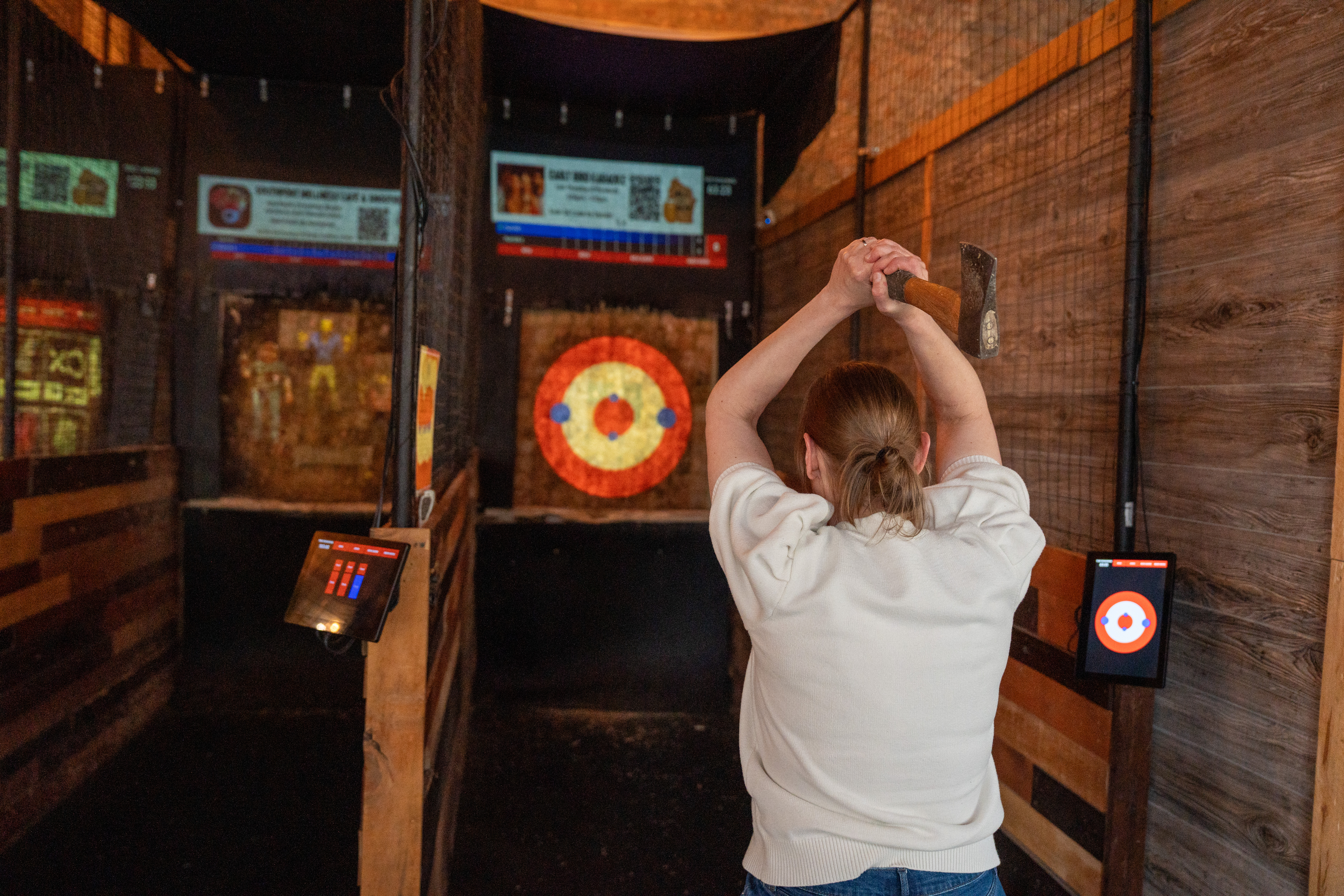 Woman throwing an axe in a lane at Hold My Beer Kenosha