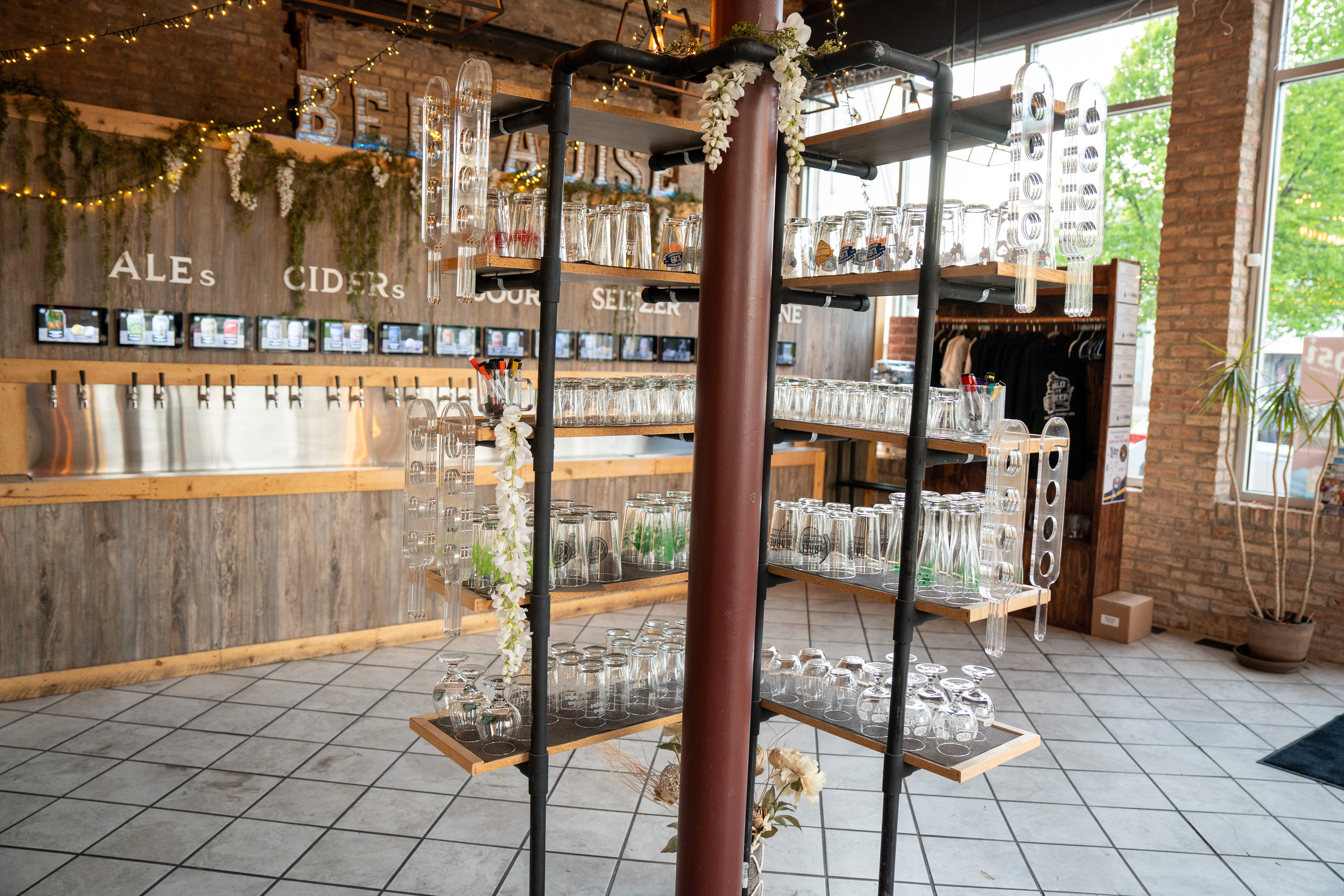 Beer wall with a tower of glassware at Hold My Beer Kenosha