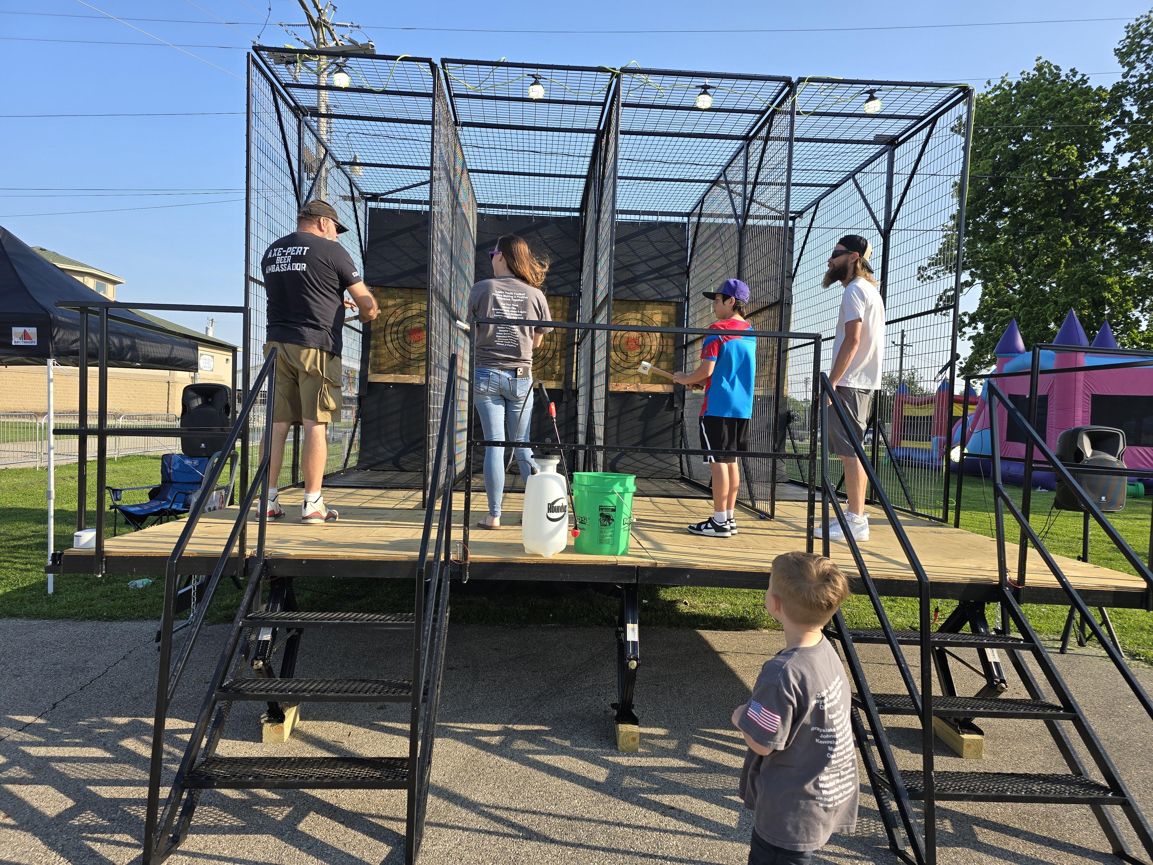 Hold My Beer mobile axe throwing trailer with guests at an outdoor event