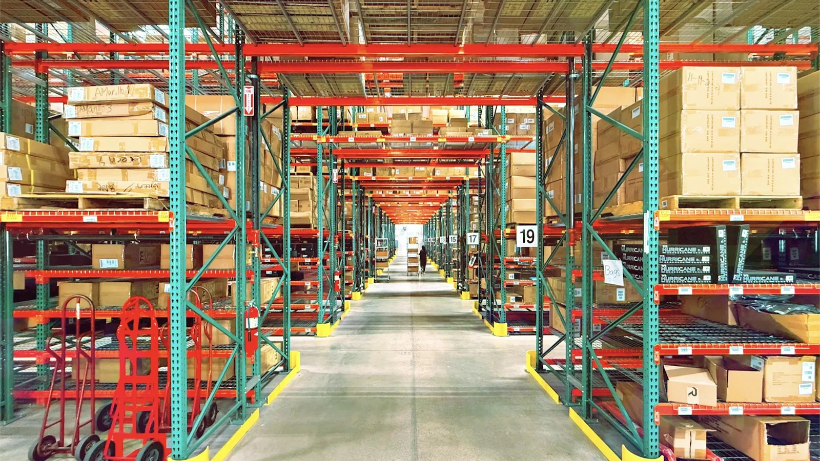 Warehouse aisle with pallet racking full of boxed stock