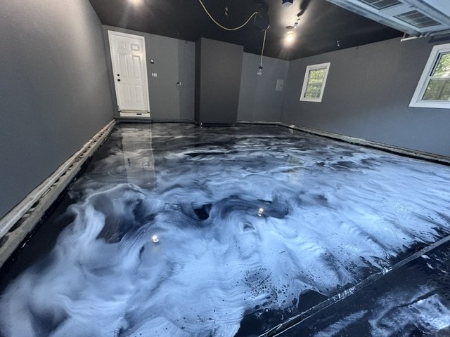 Blue and white metallic epoxy garage floor in progress by Forward 18 Coatings & Flooring
