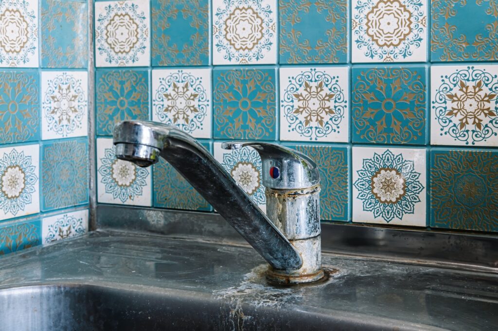 Hard water scale buildup on water faucet