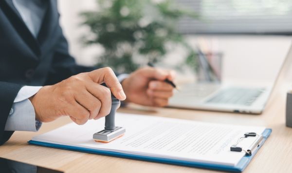 Close up of permit approval stamp on housing documents for an accessory dwelling unit project