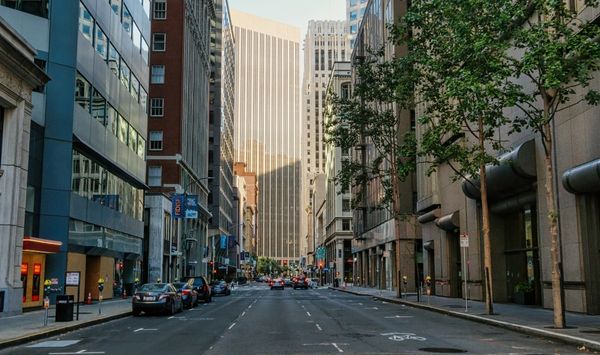 Urban neighborhood streetscape with high-rise buildings showing the lifestyle and location benefits of accessory dwelling unit living in the city