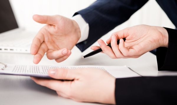 Homeowner and builder discussing ADU contract terms, warranty coverage, and project documentation