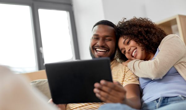 Couple relaxing together in a comfortable tiny home or ADU lifestyle setting