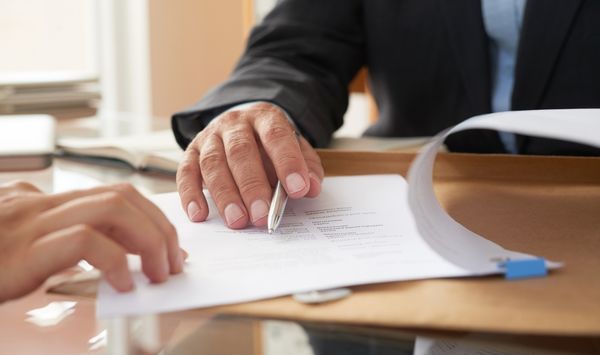 Homeowner reviewing ADU consultation paperwork for a Tolland County CT property