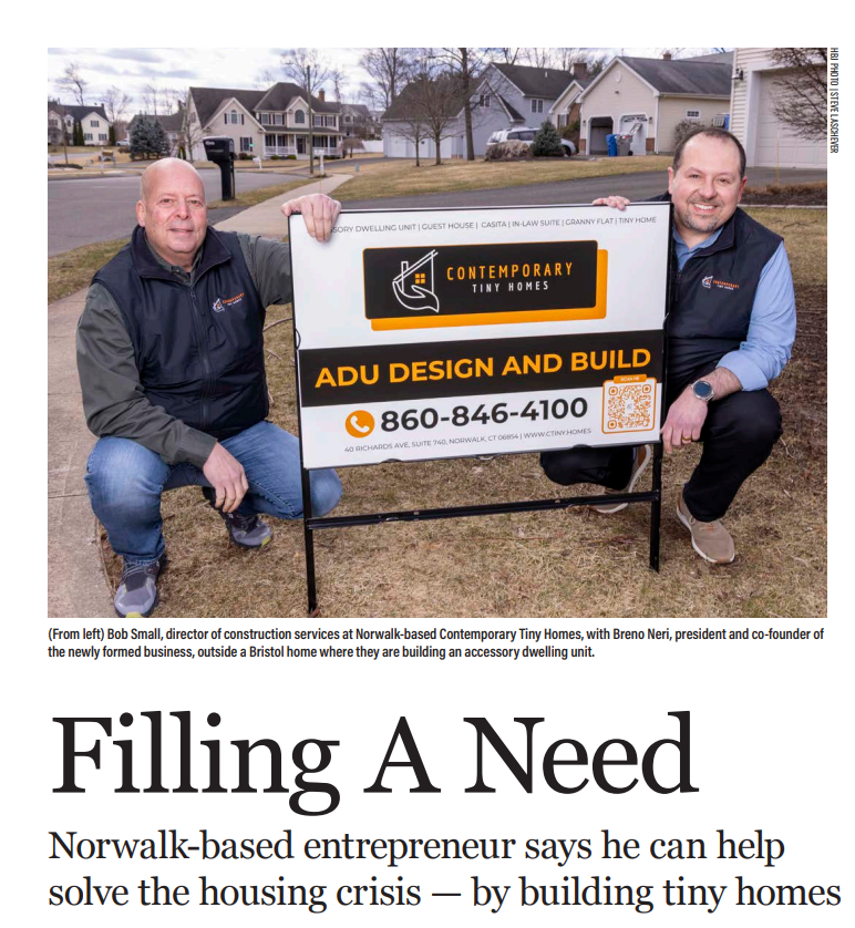 Contemporary Tiny Homes team members holding an ADU design and build sign for a Connecticut accessory dwelling unit project.