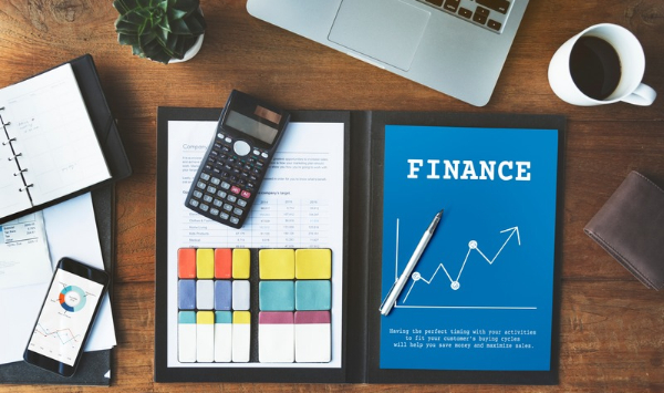 Financial planning desk with calculator and budget documents representing ADU financing and construction cost planning. 