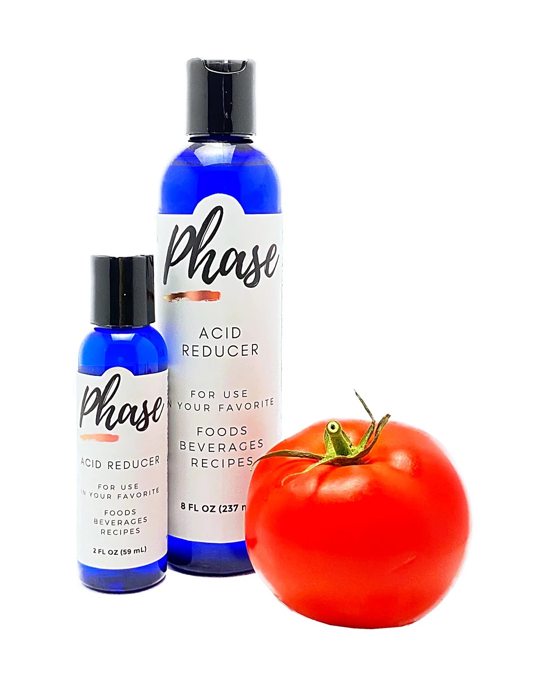 Phase bottles beside a ripe tomato