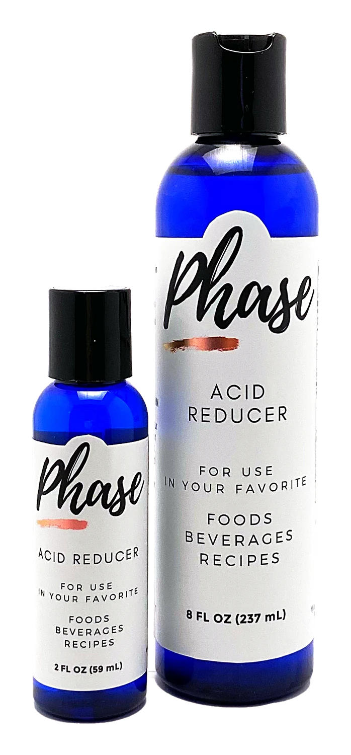 An 8 ounce and a 2 ounce cobalt blue bottle of Phase Acid Reducer