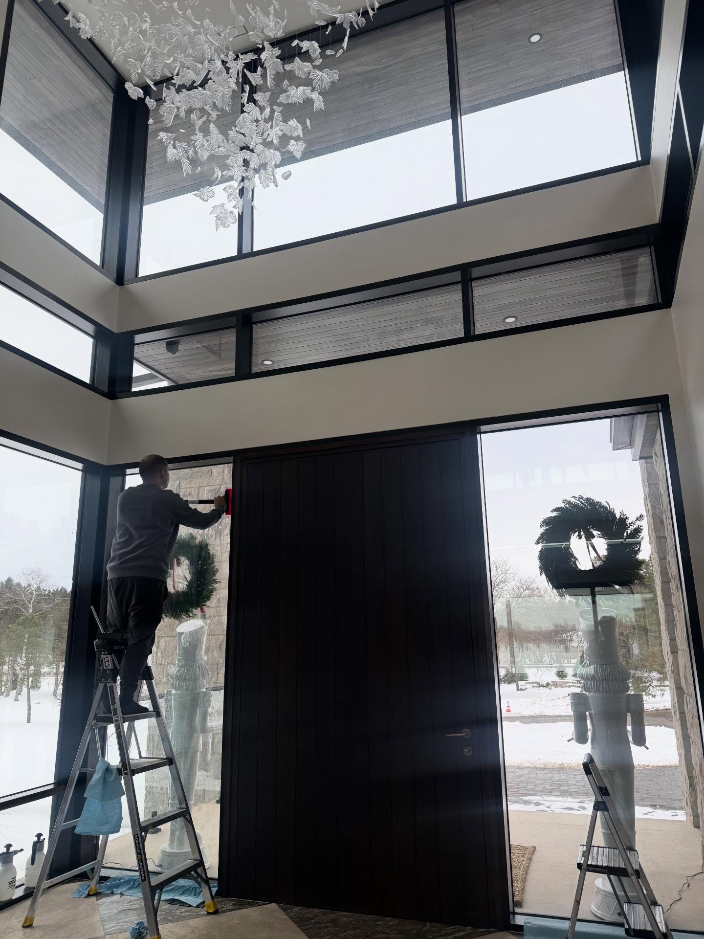 Winsolux technician installing security film on residential entry glass