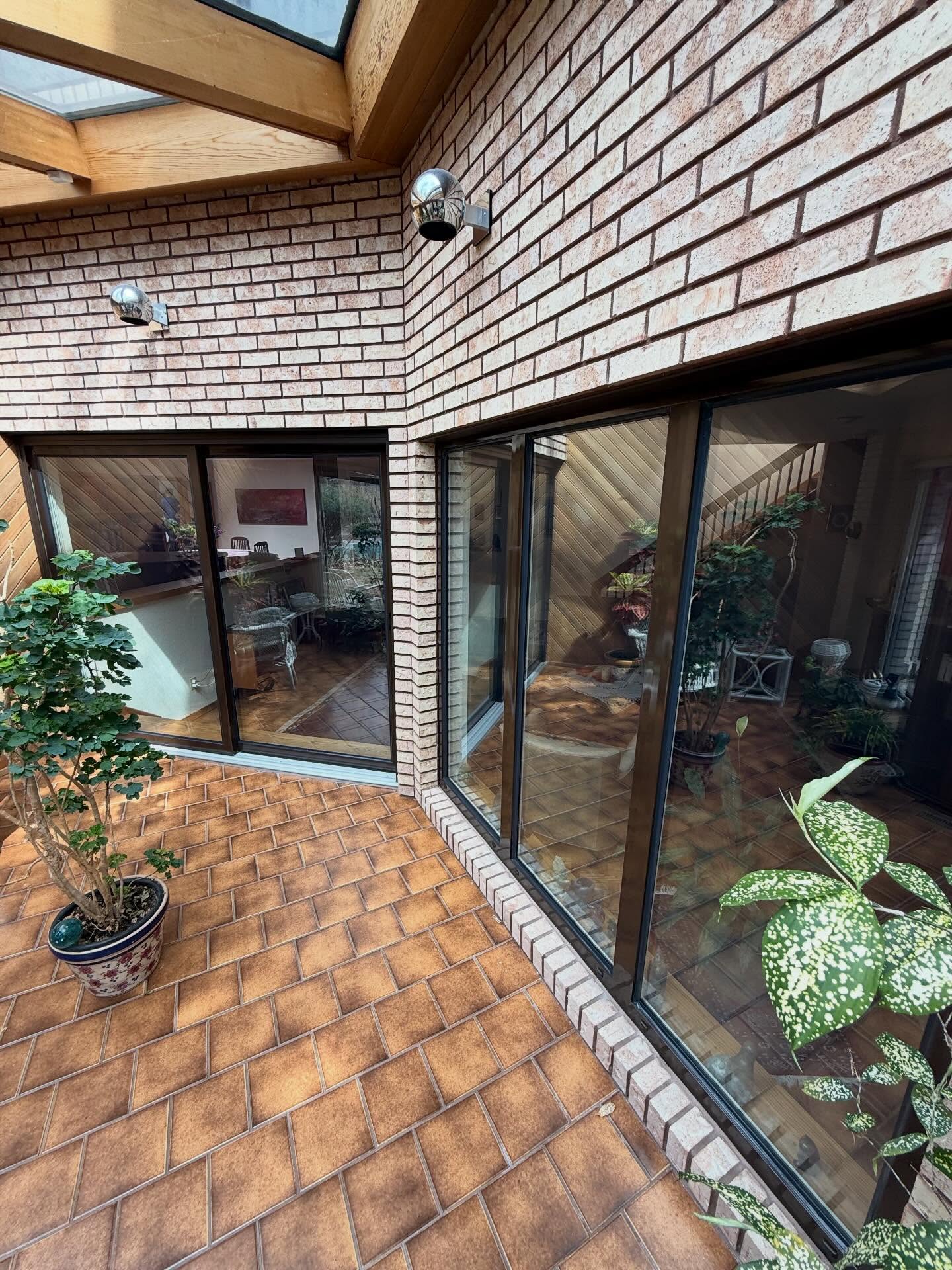 Large residential patio doors and windows protected by Winsolux