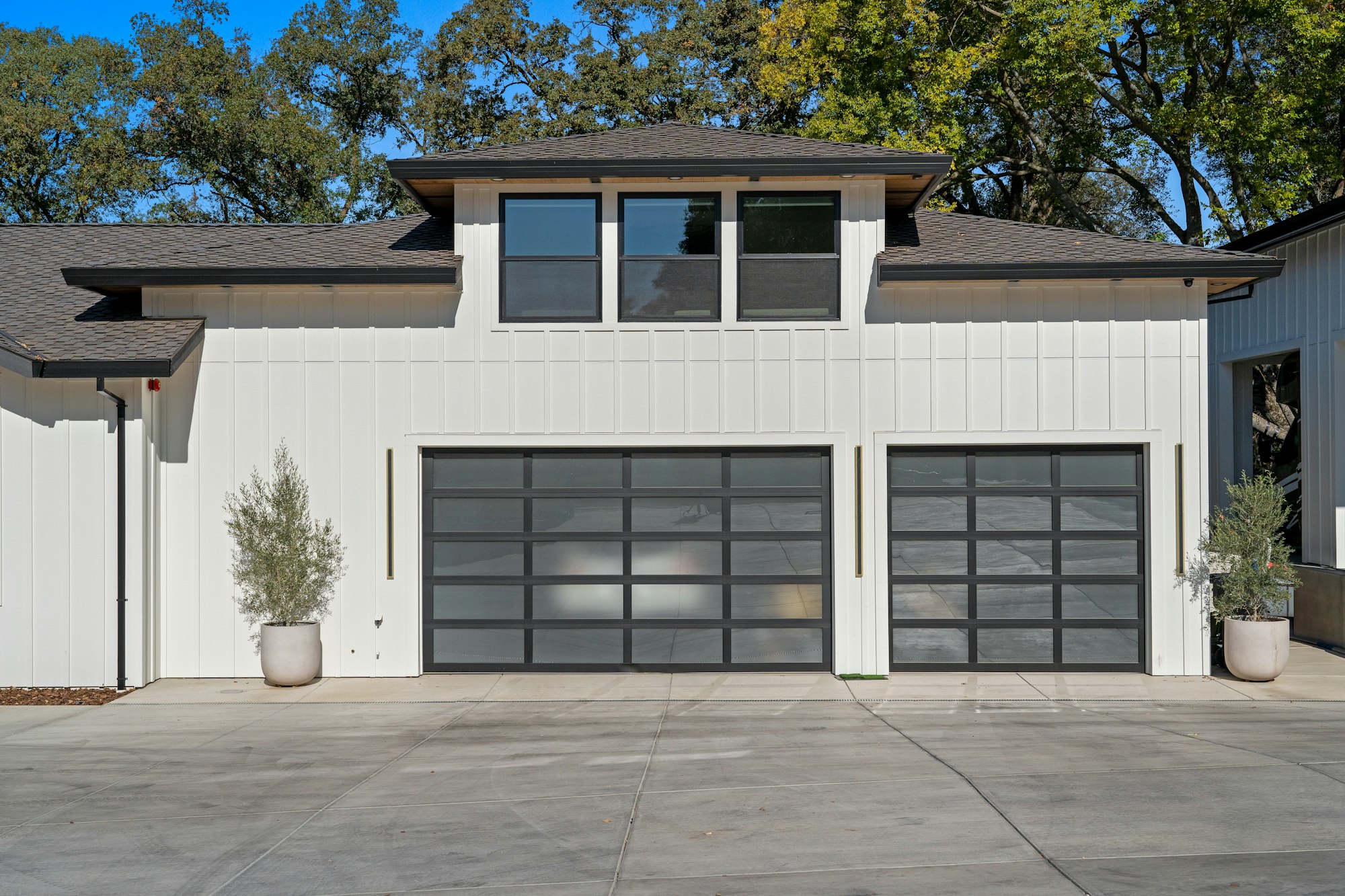 modern residential garage door installation on white home exterior
