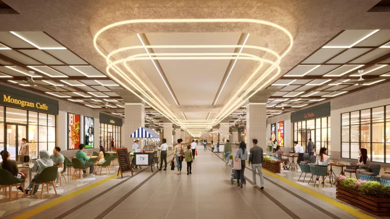 Indoor retail walkway in the podium, with café seating along a central path