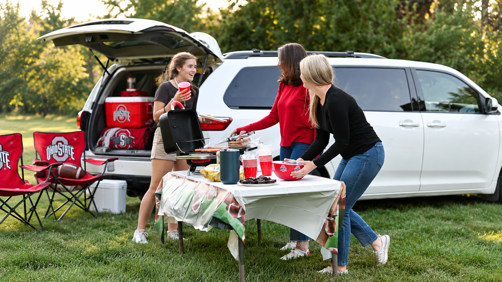 Buckeye fans at a tailgate with the served Ohio State bowl