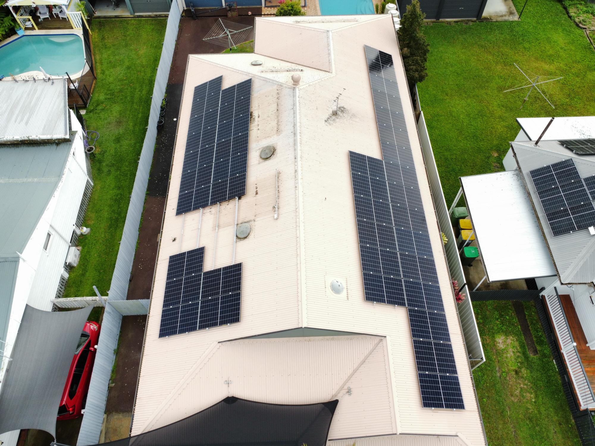Aerial view of rooftop solar panels installed by Enhance Electrical and Solar on a metal roof Aerial view of rooftop solar panels installed by Enhance Electrical and Solar on a metal roof